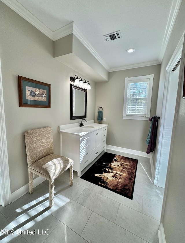 bathroom featuring baseboards, vanity, visible vents, and ornamental molding