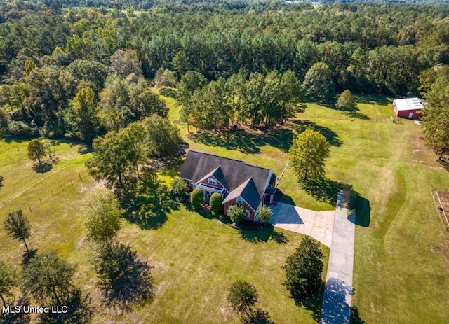 bird's eye view with a wooded view