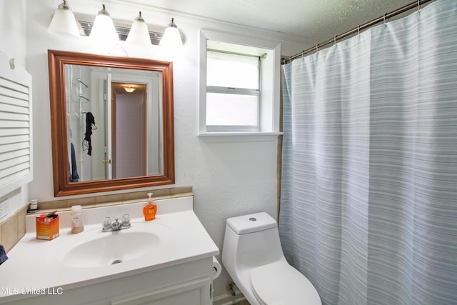 bathroom featuring toilet, curtained shower, a textured ceiling, and vanity