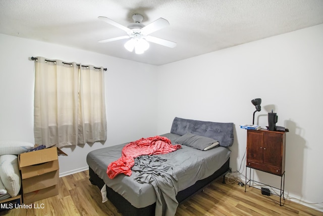bedroom featuring wood finished floors and ceiling fan