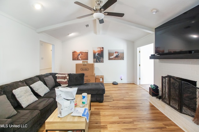 living room featuring lofted ceiling with beams, light wood-style flooring, ceiling fan, a fireplace, and visible vents