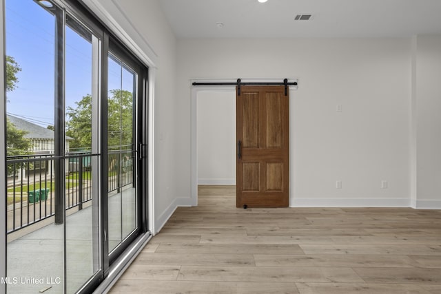 124 Court St, Bay Saint Louis, MS 39520 - spare room with light wood-type flooring and a barn door