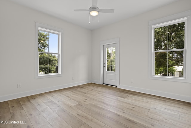 124 Court St, Bay Saint Louis, MS 39520 - empty room with plenty of natural light, light wood-type flooring, and a ceiling fan