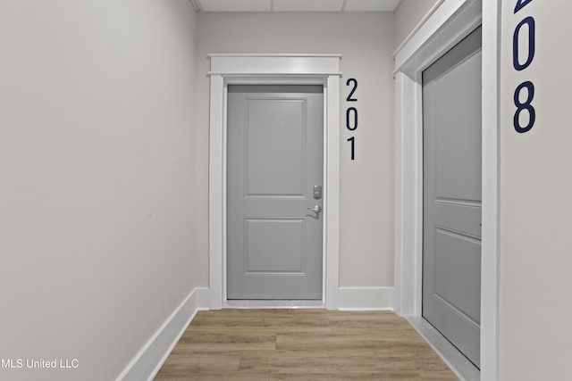 124 Court St, Bay Saint Louis, MS 39520 - doorway featuring light wood finished floors and baseboards