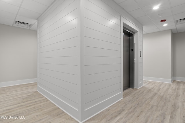 124 Court St, Bay Saint Louis, MS 39520 - hall with elevator, a paneled ceiling, light wood-type flooring, and recessed lighting