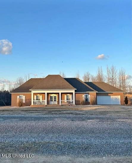 361 Cherry Bark Ln, Courtland, MS 38620 - ranch-style home featuring a porch, an attached garage, and dirt driveway