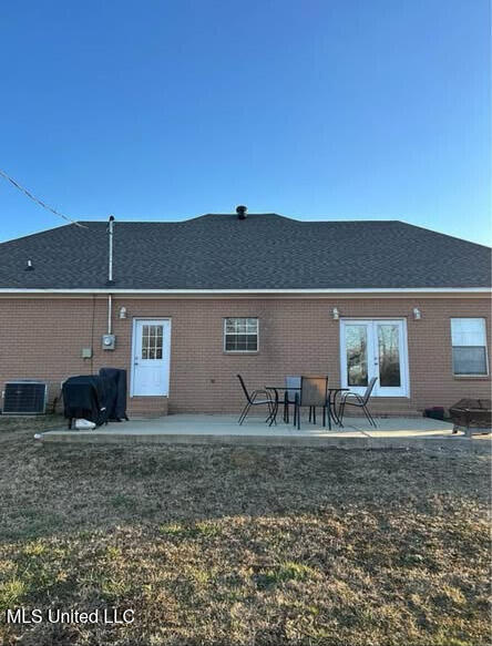 361 Cherry Bark Ln, Courtland, MS 38620 - rear view of house with brick siding, cooling unit, and a shingled roof