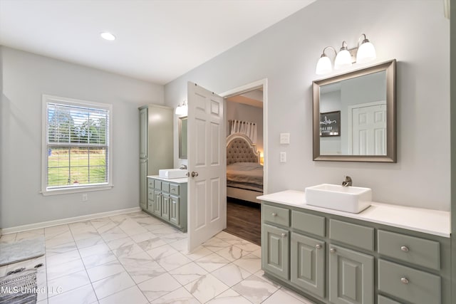 361 Cherry Bark Ln, Courtland, MS 38620 - bathroom featuring connected bathroom, two vanities, marble look tile flooring, baseboards, and recessed lighting