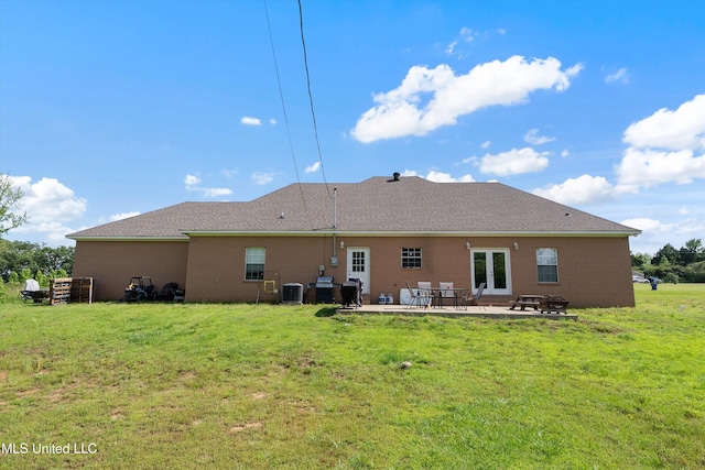 361 Cherry Bark Ln, Courtland, MS 38620 - back of property with central air condition unit, a lawn, a patio area, and brick siding