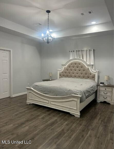 361 Cherry Bark Ln, Courtland, MS 38620 - bedroom featuring dark wood-type flooring, a tray ceiling, baseboards, and recessed lighting