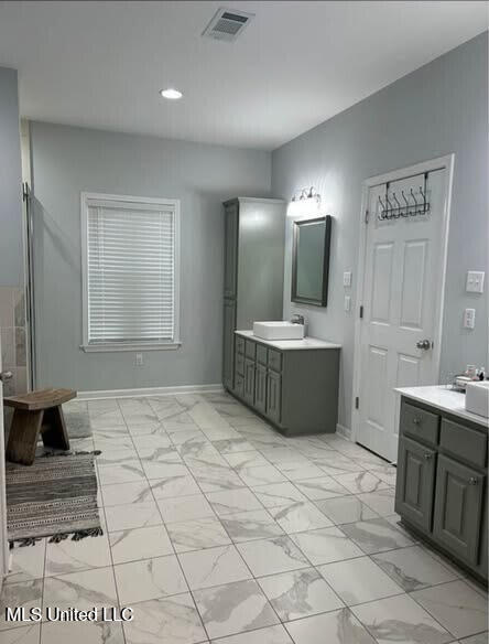 361 Cherry Bark Ln, Courtland, MS 38620 - bathroom featuring baseboards, two vanities, marble look tile flooring, and recessed lighting