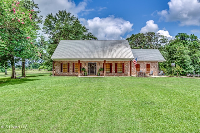 4661 Wildwood Rd, Benton, MS 39039 - view of front of house featuring a front yard, metal roof, brick siding, and a porch