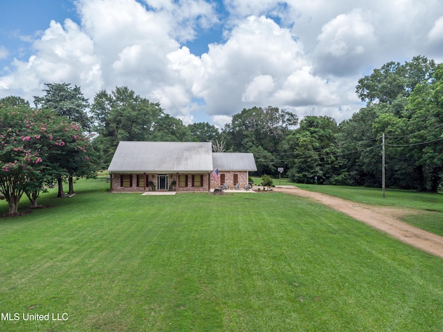 4661 Wildwood Rd, Benton, MS 39039 - view of front of home with dirt driveway, a front lawn, metal roof, and covered porch
