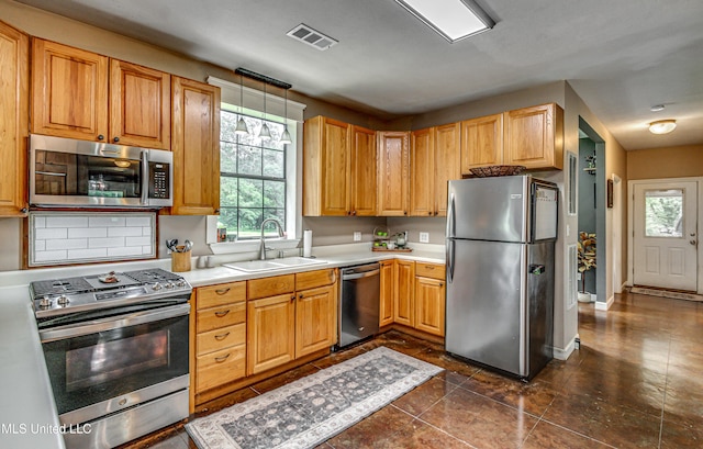 4661 Wildwood Rd, Benton, MS 39039 - kitchen with appliances with stainless steel finishes, a sink, healthy amount of natural light, and light countertops