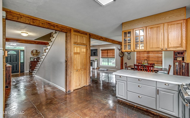 4661 Wildwood Rd, Benton, MS 39039 - kitchen featuring gray cabinets, glass insert cabinets, light countertops, baseboards, and stainless steel range
