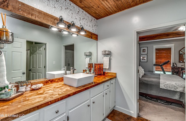 4661 Wildwood Rd, Benton, MS 39039 - full bath with ensuite bathroom, vanity, baseboards, and wood ceiling