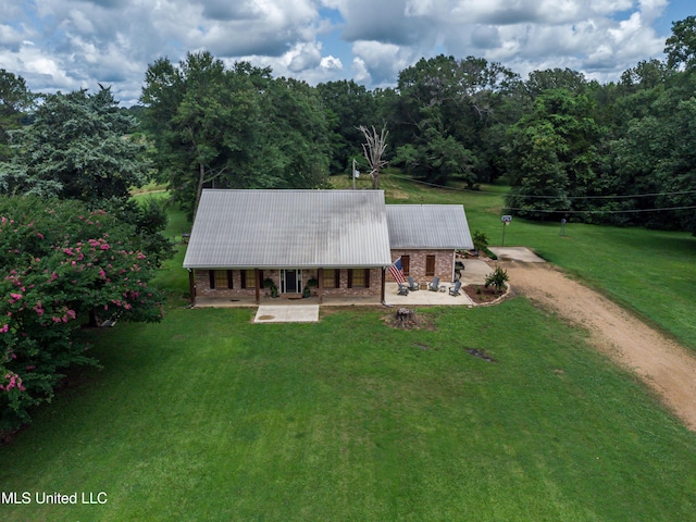 4661 Wildwood Rd, Benton, MS 39039 - view of front of house featuring driveway, a front yard, metal roof, a porch, and a wooded view