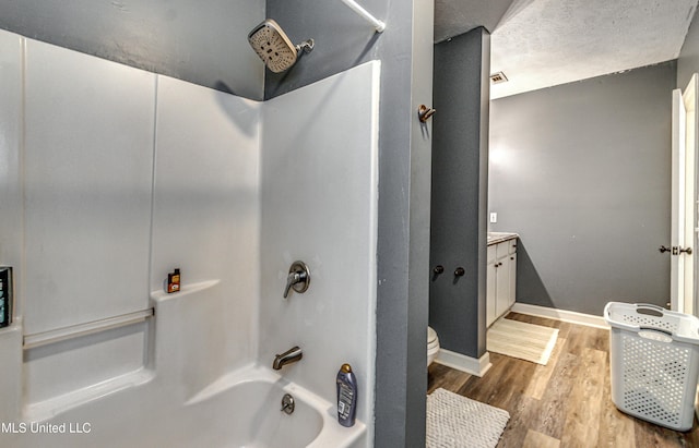 4661 Wildwood Rd, Benton, MS 39039 - bathroom featuring  shower combination, wood finished floors, vanity, toilet, and baseboards