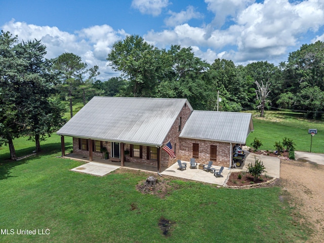 4661 Wildwood Rd, Benton, MS 39039 - view of front of home featuring metal roof, a front lawn, covered porch, and brick siding