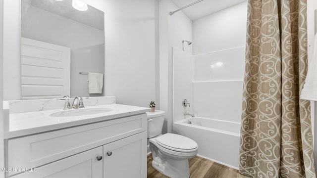 full bathroom with vanity, hardwood / wood-style flooring, toilet, and shower / bath combo with shower curtain