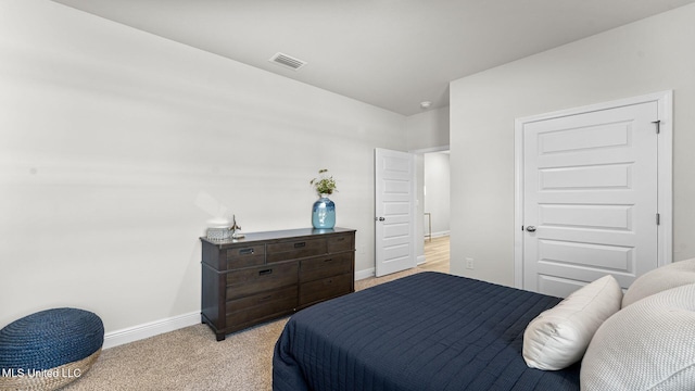 bedroom featuring light colored carpet