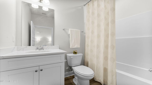 full bathroom with shower / tub combo with curtain, vanity, wood-type flooring, and toilet