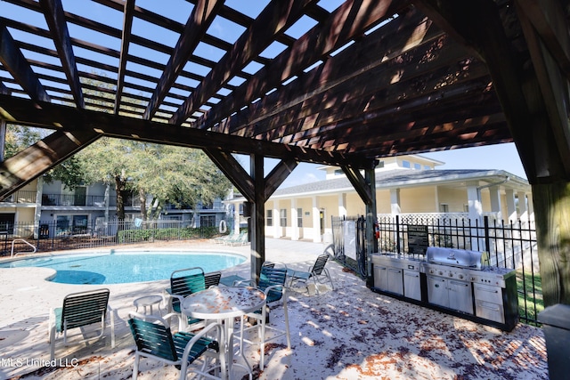 community pool with a patio area, a grill, and fence