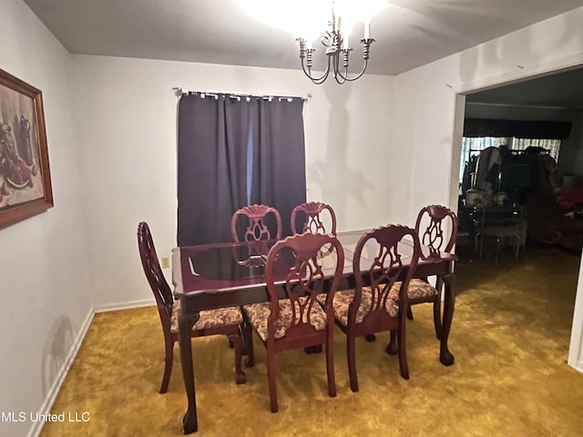 dining area featuring carpet flooring and a notable chandelier