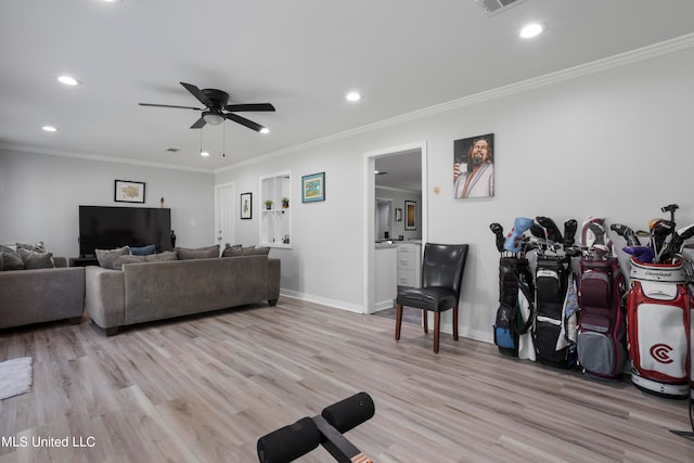 interior space featuring crown molding, light wood-type flooring, and ceiling fan