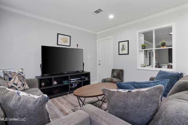 living room featuring hardwood / wood-style flooring and ornamental molding