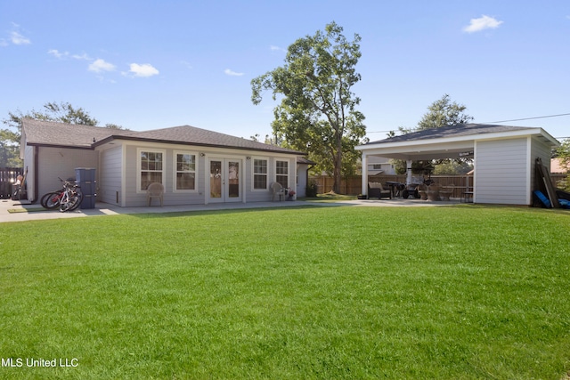 rear view of house featuring a patio, french doors, and a yard