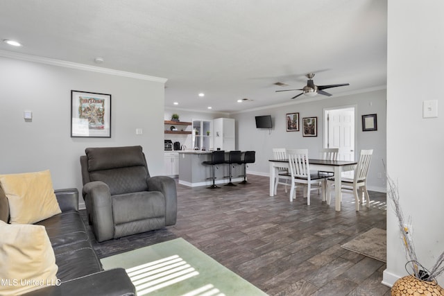 living room featuring ceiling fan, crown molding, and dark hardwood / wood-style floors