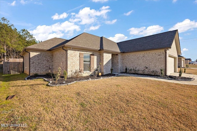 view of front of home with a front lawn and a garage