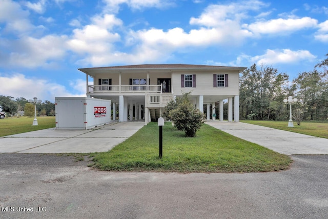10053 Kingston Rd, Bay Saint Louis, MS 39520 - coastal home with a carport, driveway, and a front lawn