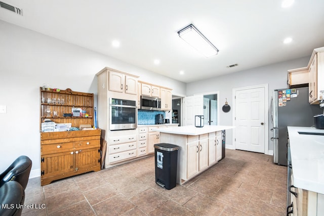 10053 Kingston Rd, Bay Saint Louis, MS 39520 - kitchen with appliances with stainless steel finishes, a kitchen island, light countertops, recessed lighting, and baseboards