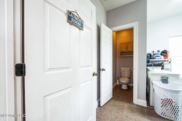 10053 Kingston Rd, Bay Saint Louis, MS 39520 - bathroom featuring toilet, baseboards, and tile patterned flooring