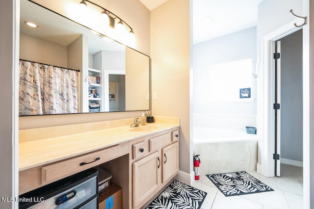 10053 Kingston Rd, Bay Saint Louis, MS 39520 - bathroom with vanity, a bath, tile patterned floors, and baseboards