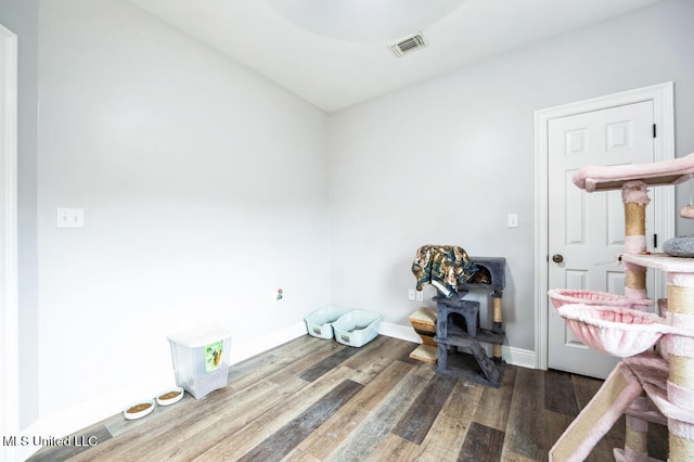 10053 Kingston Rd, Bay Saint Louis, MS 39520 - bedroom featuring wood finished floors, baseboards, and a wood stove