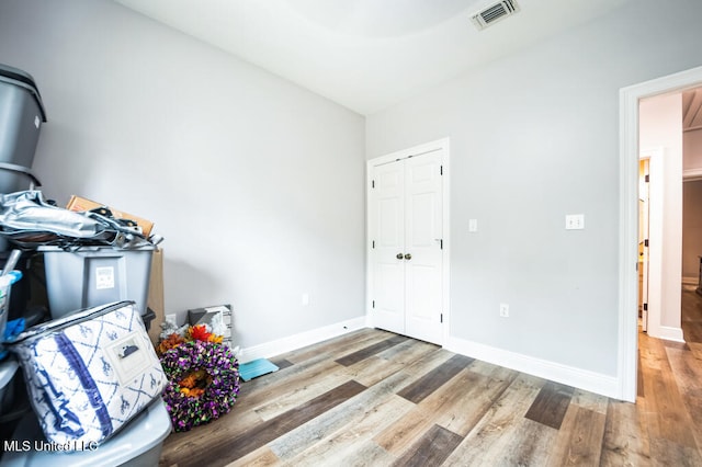 10053 Kingston Rd, Bay Saint Louis, MS 39520 - bedroom featuring wood finished floors, a closet, and baseboards