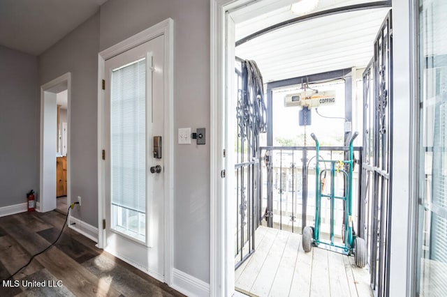 10053 Kingston Rd, Bay Saint Louis, MS 39520 - doorway with wood finished floors and baseboards