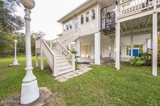 10053 Kingston Rd, Bay Saint Louis, MS 39520 - rear view of property featuring stairway and a yard