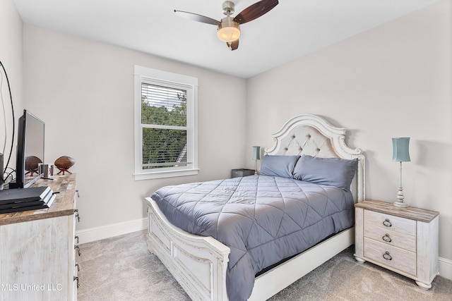 bedroom with baseboards, a ceiling fan, and light colored carpet