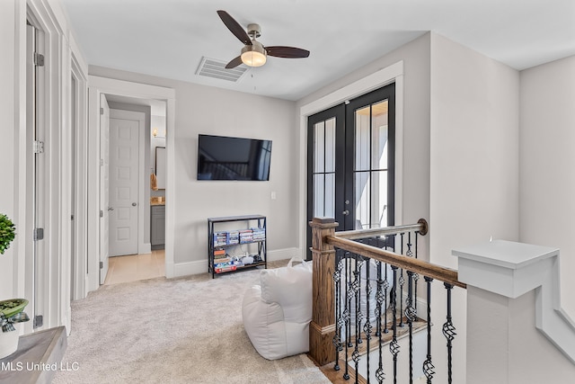 hallway with baseboards, visible vents, an upstairs landing, french doors, and carpet floors