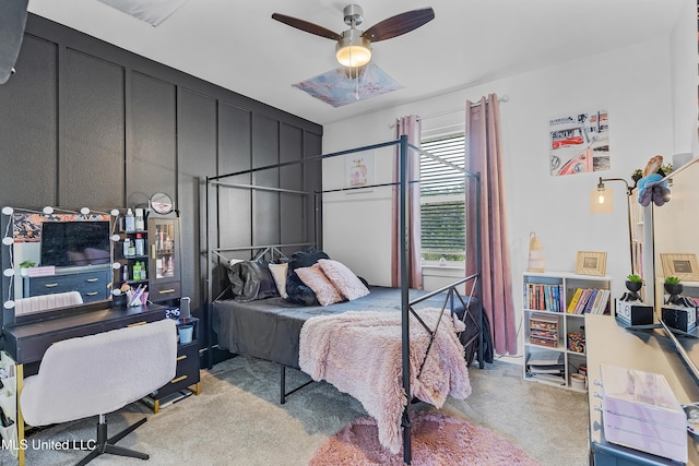 bedroom featuring carpet flooring and a decorative wall