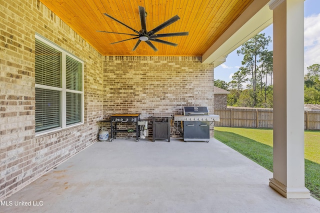 view of patio featuring ceiling fan, grilling area, and fence