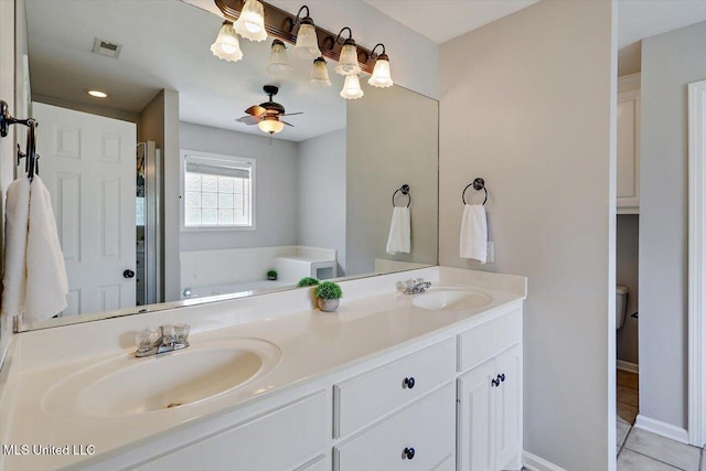 bathroom with a garden tub, a sink, visible vents, and double vanity