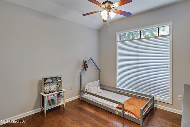 bedroom featuring baseboards, vaulted ceiling, and hardwood / wood-style flooring