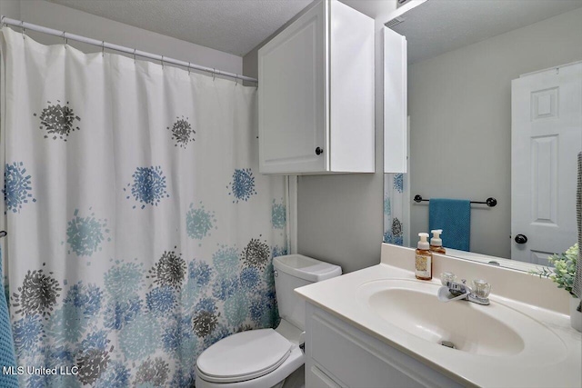 bathroom featuring toilet, a textured ceiling, curtained shower, and vanity