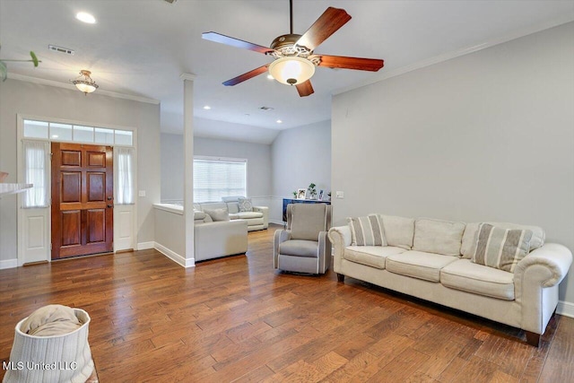 living area with crown molding, a ceiling fan, baseboards, and wood finished floors
