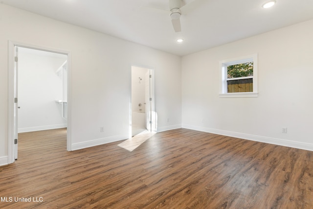 spare room featuring ceiling fan and dark hardwood / wood-style floors